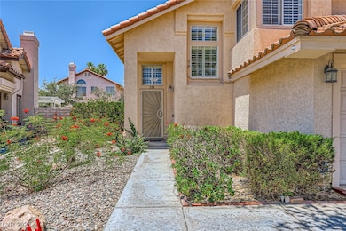 Property entrance with stucco siding and a tiled r
