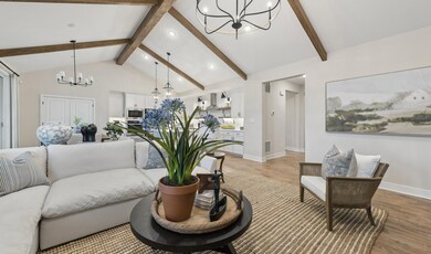 Great room with stained ceiling beams & vaulted ceiling
