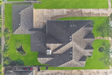 This aerial view shows the extended driveway that leads to the 3-car wide detached garage that offers plenty of parking for guests and residents alike!