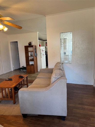 Living area featuring wood finished floors and ceiling fan