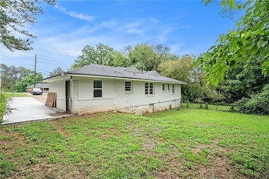 Rear view of house with brick siding and a patio area