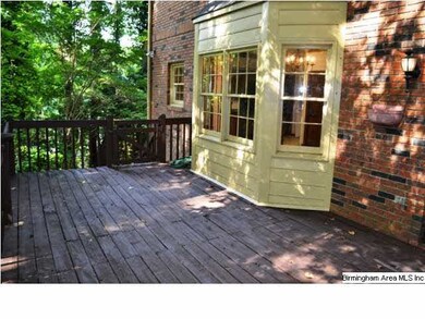 Large deck off the den overlooks the shaded back y