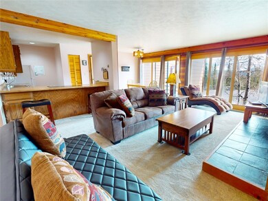 Living room featuring carpet floors and beam ceili