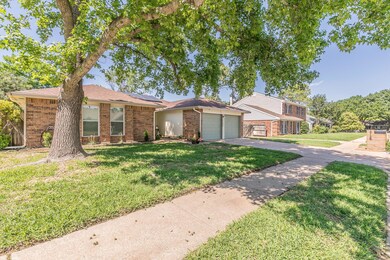 View of front of home featuring a front lawn and a garage