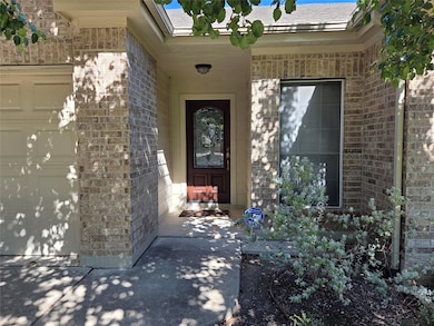 Doorway to property featuring brick siding