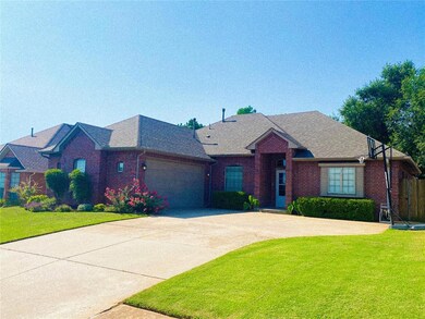 View of front of home with a garage and a front ya