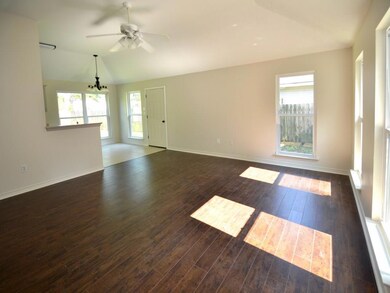 Large den with new laminate wood flooring.