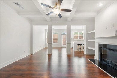 Unfurnished living room featuring decorative colum