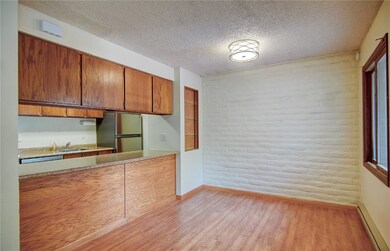 Kitchen with freestanding refrigerator, a baseboar