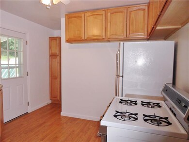 Kitchen offers Pergo flooring, gas stove, refriger
