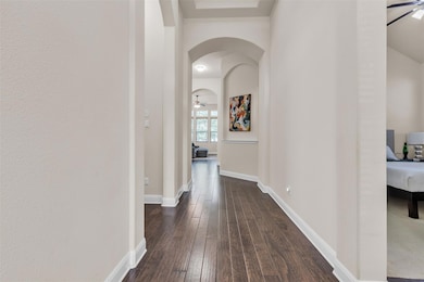 Hall featuring dark wood finished floors and arch