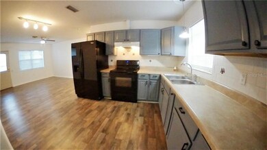 This view shows the nice new flooring flowing from the kitchen into the living room.