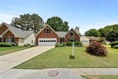 Traditional home featuring brick siding, driveway,