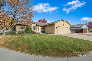 Single story home with driveway and a garage
