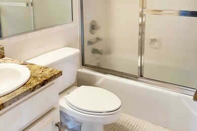 Bathroom with shower / bath combination with glass door