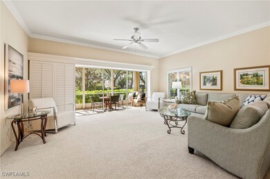 Carpeted living room featuring ceiling fan and cro