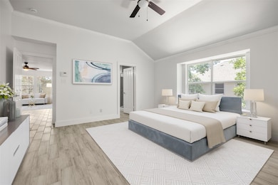 Bedroom featuring crown molding, light wood-style