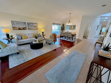 Tiled living room featuring ornamental molding, a