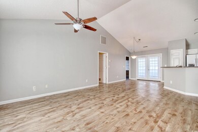 Unfurnished living room with ceiling fan, light ha