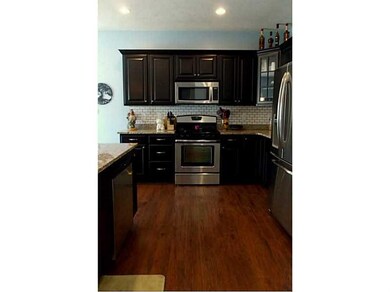 Kitchen. Dark wood cabinetry and Hardwood Floors
