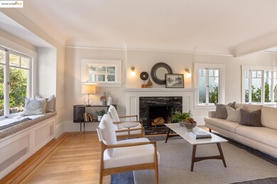 Living room featuring radiator heating unit, a high end fireplace, wood finished floors, healthy amount of natural light, and crown molding