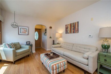 Living room with refinished hard wood floors and a
