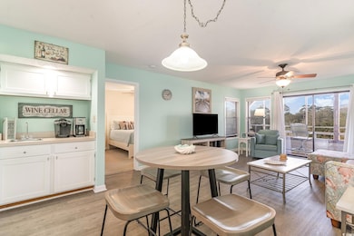 Dining room with light wood finished floors, a cei