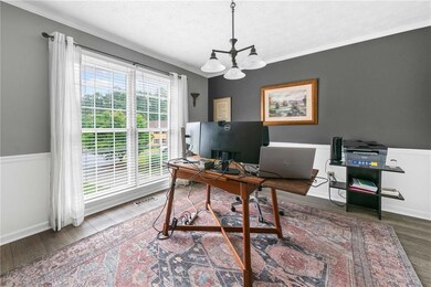 Office area with a chandelier, wood finished floor