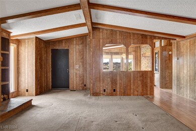 Unfurnished living room featuring a textured ceili