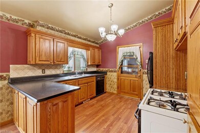Kitchen featuring black appliances, a chandelier, 