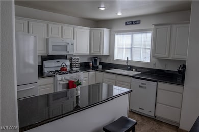 Kitchen featuring dark countertops, recessed light