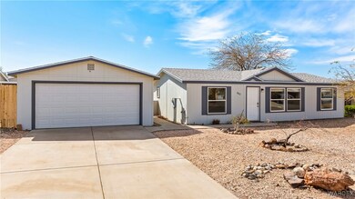 Ranch-style house with a garage, a shingled roof,