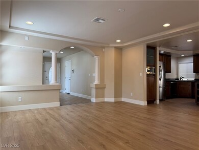 Unfurnished living room featuring ornate columns,