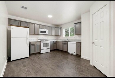 This well-lit kitchen features granite countertops