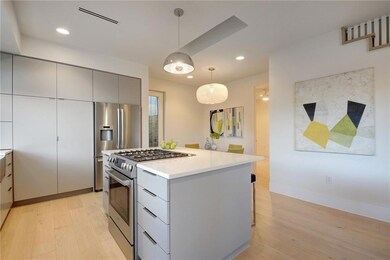 Kitchen with stainless steel appliances, gray cab