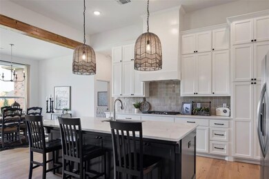 Kitchen featuring an island with sink, white cabin