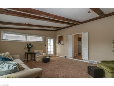 Spacious 17x13 family room with beamed ceilings, d