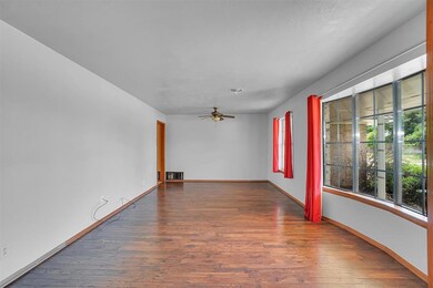 Empty room with ceiling fan and dark wood-type flo