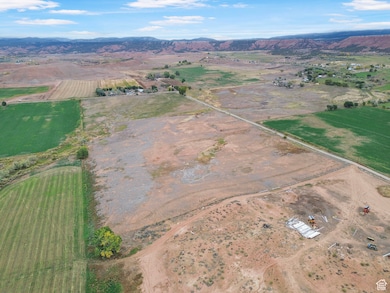 Aerial overview of property's location with rural landscape and mountains