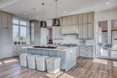 Every detail was considered—from the integrated vent hood to the handmade tile backsplash. This is a kitchen built for those who appreciate quiet craftsmanship.