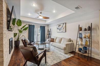 Living room with dark wood-type flooring, a raised