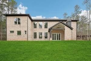 Rear view of home with a ceiling fan on back patio