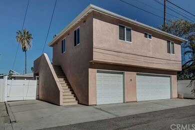Back Unit, see the stairs leading up to the 2 Bedroom apartment above this 3 Car Garage.  See additional parking space to the left