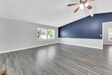 Unfurnished living room featuring hardwood / wood-
