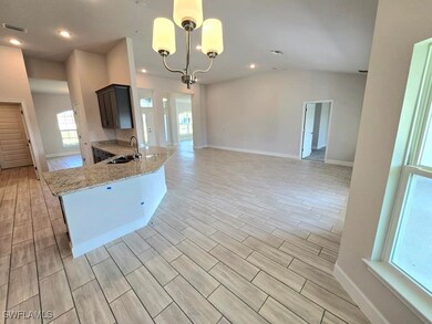 Kitchen with sink, kitchen peninsula, light hardwo