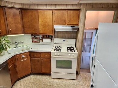 Kitchen featuring sink, white appliances, and coun