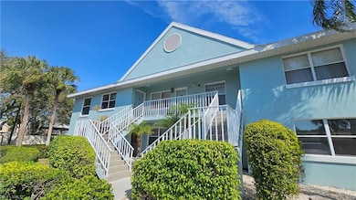 View of front of house featuring stairway, covered