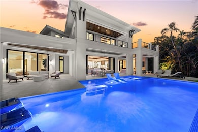 Back house at dusk with an outdoor living space, a