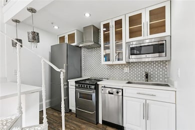 Renovated kitchen with granite countertops, stainless appliances, and open layout for modern living.