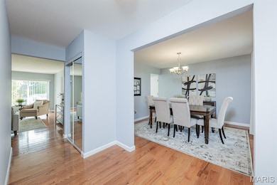 Dining room with a chandelier and light wood-style flooring
